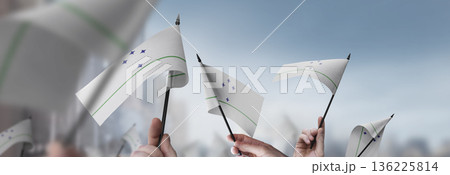 Mercosur flags in their hands on a blurred urban background 136225814