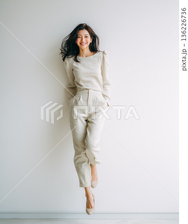 【軽やかなジャンプポートレート】ナチュラルコーデの女性と白背景｜明るく前向きな印象のライフスタイル素 136226736