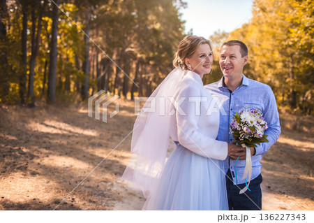 newlyweds are walking in the green Pine forest newlyweds are walking in the green Pine forest 136227343