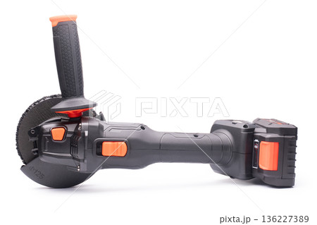 Cordless angle grinder for cutting, grinding, and polishing. On a white background in isolation. Cordless angle grinder for cutting, grinding, and polishing. On a white background in isolation. 136227389