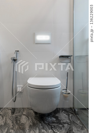 Modern Bathroom with Wall-Mounted Toilet and Dark Marble Floor Modern Bathroom with Wall-Mounted Toilet and Dark Marble Floor 136229003