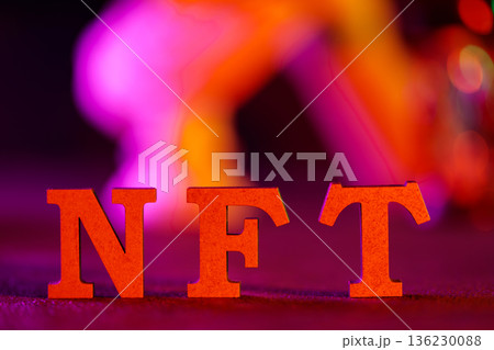 Red Orange NFT Letters with Colorful Bokeh Lights Background Non-Fungible Token Concept 136230088