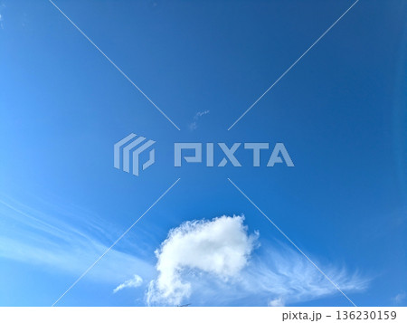 White fluffy clouds on a beautiful clear blue sky White fluffy clouds on a beautiful clear blue sky 136230159