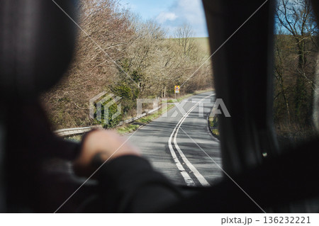 Rear passenger point of view from interior of car travelling, looking out the window on a country road - speed on single carriageway, trip concept Rear passenger point of view from interior of car travelling, looking out the window on a country road - speed on single carriageway, trip concept 136232221