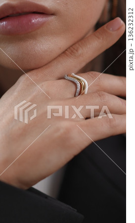 Woman's hand with beautiful ring touching her delicate face skin Woman's hand with beautiful ring touching her delicate face skin 136232312