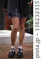 Young woman in a school uniform dancing outdoors 136232315