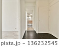 A sleek and modern hallway showcasing minimalist design elements. The space features a clear view into a stylish bathroom with clean lines and neutral colors. 136232545