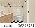 A sleek and contemporary bathroom featuring white tiled walls, a wooden vanity, and stylish black and white flooring. Perfect for design inspiration and home decor ideas. 136232551