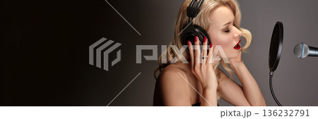 Female Singer In Recording Studio, Glamorous Session Vocalist Recording Pop Ballad Into Condenser Microphone, Wearing Large Headphones And Retro Makeup, Dramatic LowKey, Indie Artist, Pop Music Song 136232791