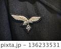 Close-up of a Luftwaffe breast eagle badge sewn on to the jacket of a German WW2 military uniform 136233531