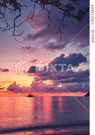 A beautiful sunset seen from the beach on one of the small islands of the Philippines. 136235604