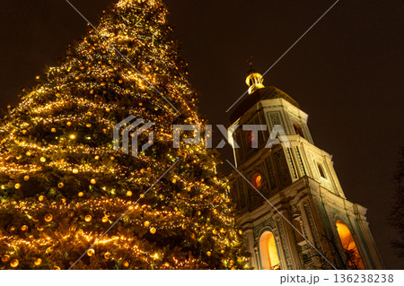Kyiv Ukraine The main Christmas tree of the country near St. Sophia Cathedral, 11th century. Christmas lights at night sky. Bell tower square Kyiv Ukraine The main Christmas tree of the country near St. Sophia Cathedral, 11th century. Christmas lights at night sky. Bell tower square 136238238