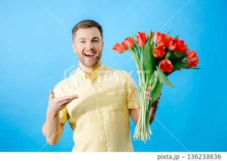Man holding bouquet of red tulips Man holding bouquet of red tulips 136238636