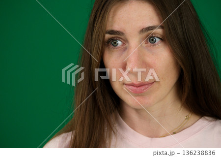 surprised woman sad eyes Portrait of a scared or very surprised girl on a white studio background. 136238836
