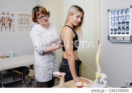 Doctor examining patient spine for chiropractic treatment 136238864