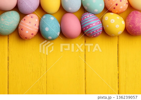 Colorful Easter Egg side border over a bright yellow wood background. Copy space. Colorful Easter Egg side border over a bright yellow wood background. Copy space. 136239057