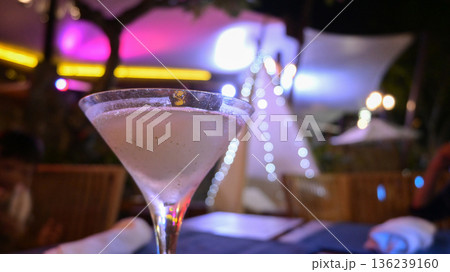 glass of cocktail in night bar, blur colorful background 136239160
