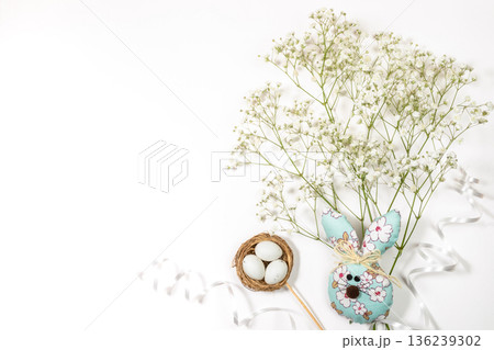 Decorative Easter bunny with flowers and eggs on white background Top view Copy space 136239302