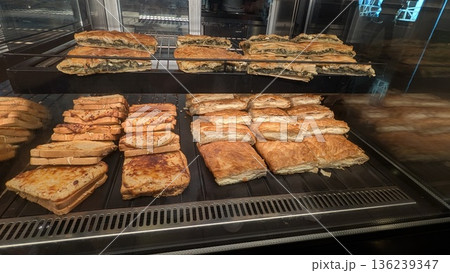 Cheese pies, spinach pies, and croque monsieur in the showcase Cheese pies, spinach pies, and croque monsieur in the showcase 136239347