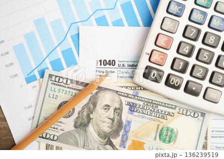 Tax form 1040 U.S. Individual Income Tax Return with dollar banknotes money. Tax form 1040 U.S. Individual Income Tax Return with dollar banknotes money. 136239519