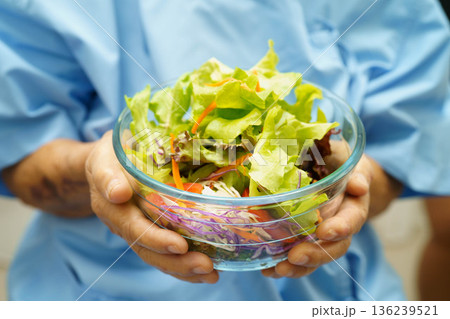 Asian elderly woman patient holding healthy food for patient in hospital, nutrition and vitamin. 136239521