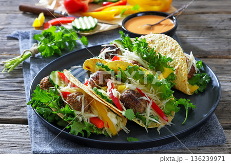 Lamb meatball tacos with fresh veggies on a plate Lamb meatball tacos with fresh veggies on a plate 136239971