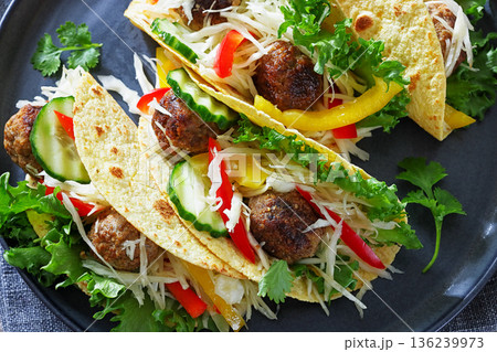Beef meatball tacos with fresh veggies on a plate 136239973