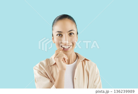 Happy attractive woman showing healthy white teeth, promoting dental care, friendly smiling Happy attractive woman showing healthy white teeth, promoting dental care, friendly smiling 136239989