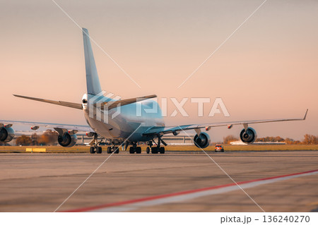 commercial airplane flying above the clouds 136240270