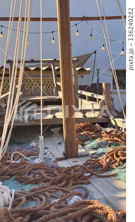 Maritime Morning Scene. Sailor Tending Lines At Dawn. Sunrise Over Vessel With Sailors Preparing Ropes. Quiet Maritime Environment With Sailors Organizing Gear At Sunrise 136240282