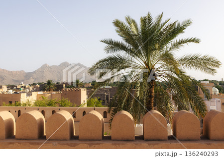 Nizwa Fort walls with old town in background in Oman 136240293