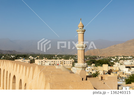 Nizwa Fort walls and Al Qalaa Mosque in afternoon light in Oman 136240315