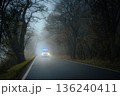 Emergency ambulance speeding on road in heavy fog 136240411