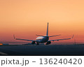 Airplane at airport at golden sunrise 136240420