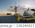 Boarding to airplane at airport 136240421