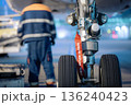 Aircraft nose wheel with red flag Remove Before Flight 136240423