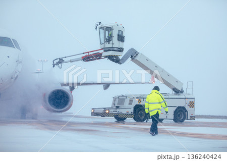 Deicing of airplane before flight at airport Deicing of airplane before flight at airport 136240424