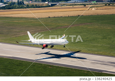 Airplane landing on airport runway 136240425