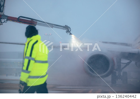 Deicing of airplane before flight at airport Deicing of airplane before flight at airport 136240442