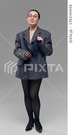Minimalist woman in tailored jacket studio portrait. Minimalist woman in tailored jacket studio portrait. 136240448