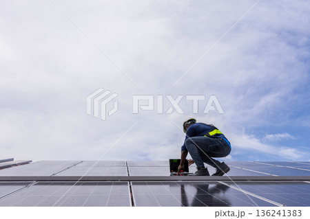 Engineer service check installation solar cell on the roof of factory. 136241383