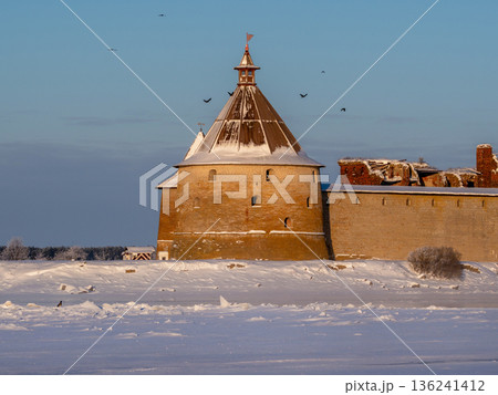ancient fortress, a tower with a conical roof covered with snow ancient fortress, a tower with a conical roof covered with snow 136241412