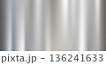 Silver brushed stainless steel surface with vertical reflections 136241633