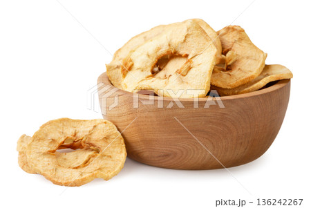 Dried apples in a wooden plate and a pile on a white background. Isolated Dried apples in a wooden plate and a pile on a white background. Isolated 136242267
