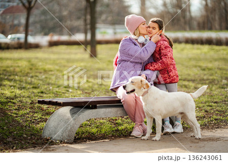 Mother daughter dog family bonding in park 136243061