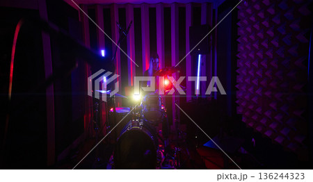 Drummer playing drums during music studio rehearsal 136244323