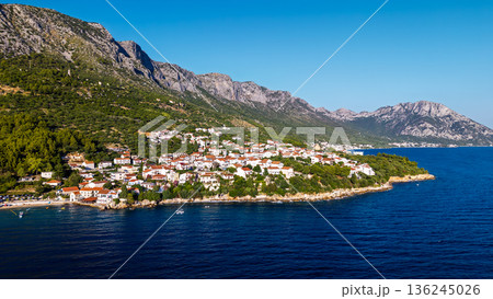 Aerial view of Croatian seaside town with red roofs and rocky coastline on Adriatic Sea Aerial view of Croatian seaside town with red roofs and rocky coastline on Adriatic Sea 136245026
