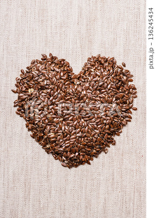 Raw flax seeds linseed heart shaped Raw flax seeds linseed heart shaped 136245434