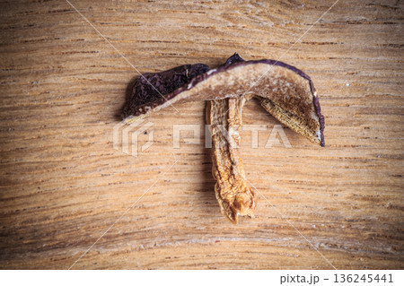 Dry mushroom boletus on wooden table. 136245441
