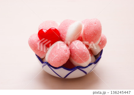 Pink jellies or marshmallows with sugar in bowl 136245447